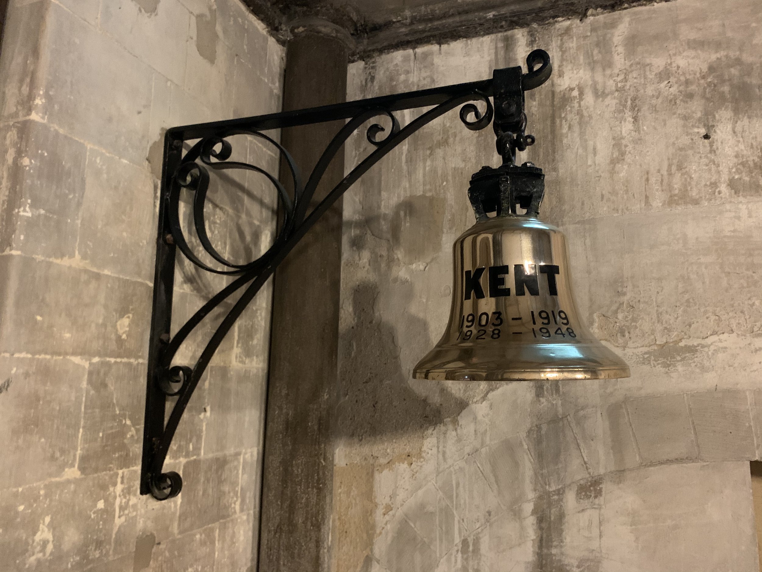Photograph of the ship bell of HMS Kent in the South Quire Aisle.