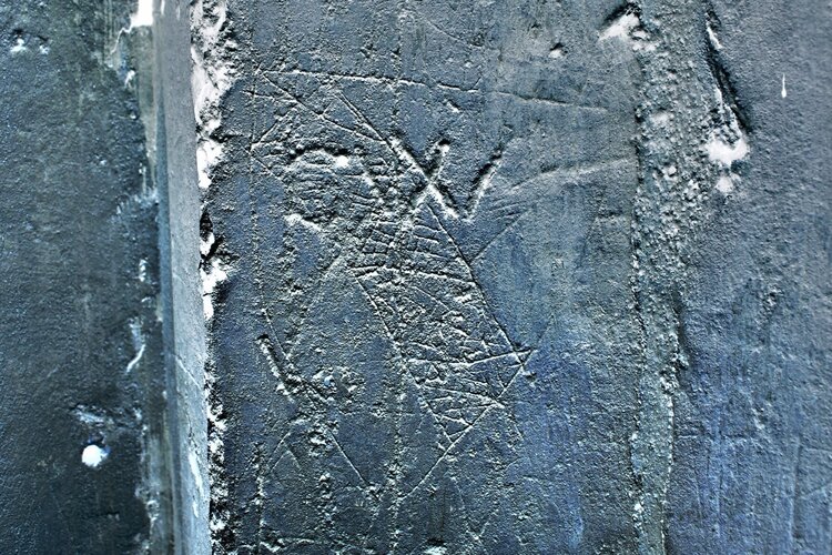 High-contrast negative photograph of a heraldic graffito on a pier in the Lady Chapel.