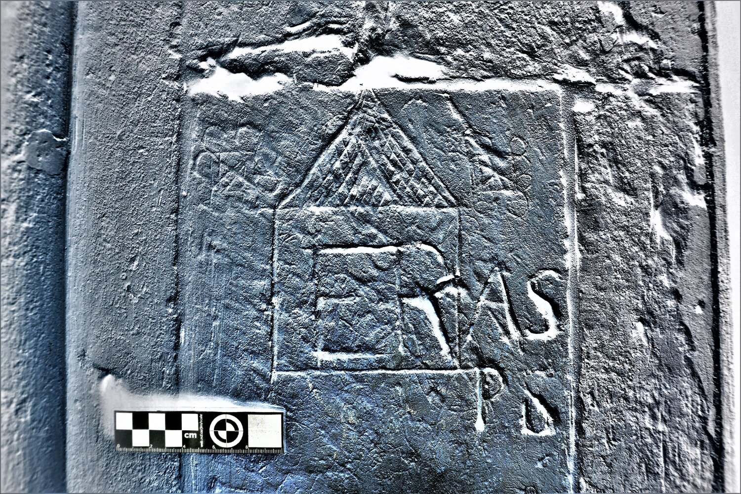 High-contrast negative photograph of a graffito with a decorative border in the Lady Chapel.