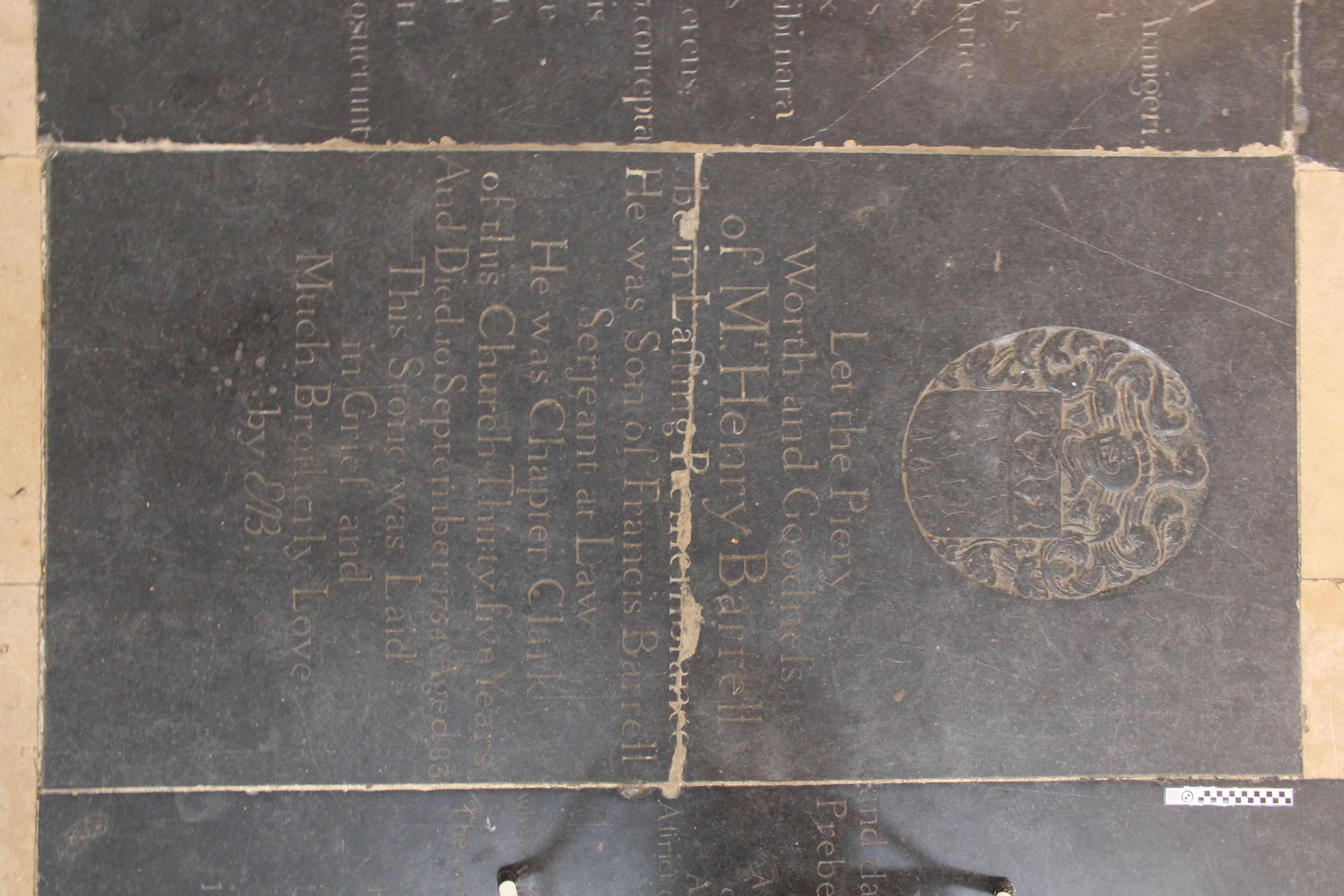 Photograph of the ledger stone dedicated to Henry Barrell in the center nave aisle.