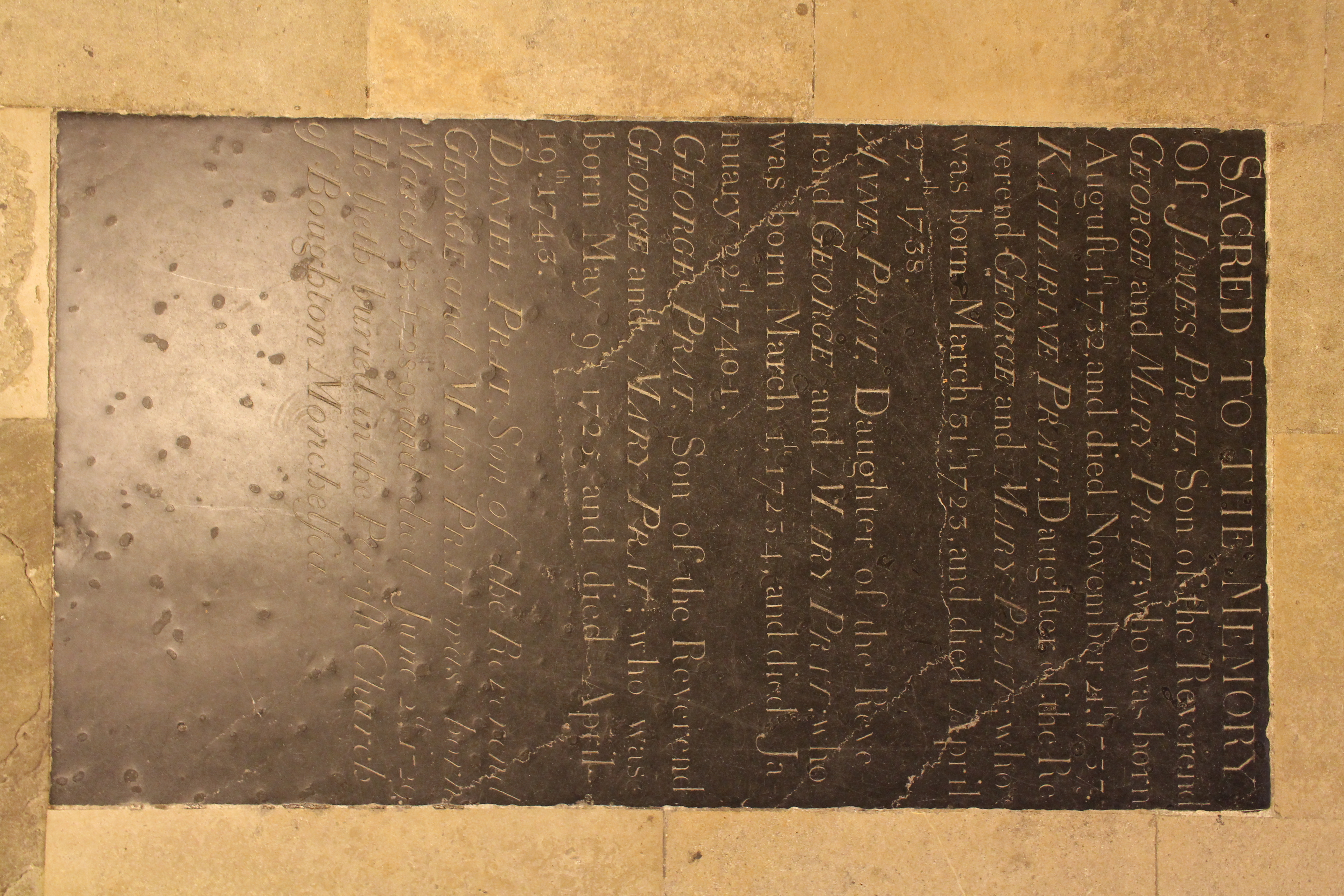 Photograph of the ledger stone dedicated to the children of George and Mary Prat in the south quire aisle.